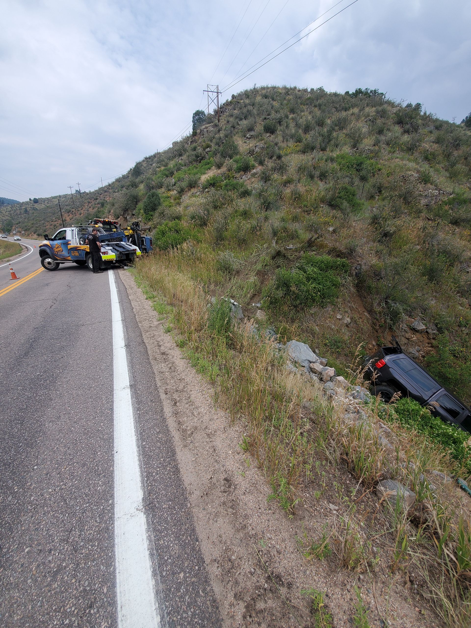 D&J wrecker recovering a vehicle from a mountain embankment
