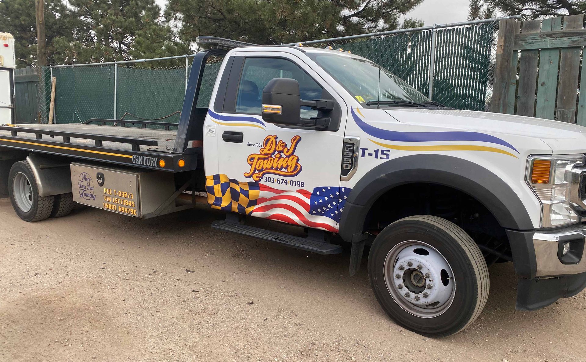 D&J Towing Ford F-550 flatbed tow truck with American flag graphics